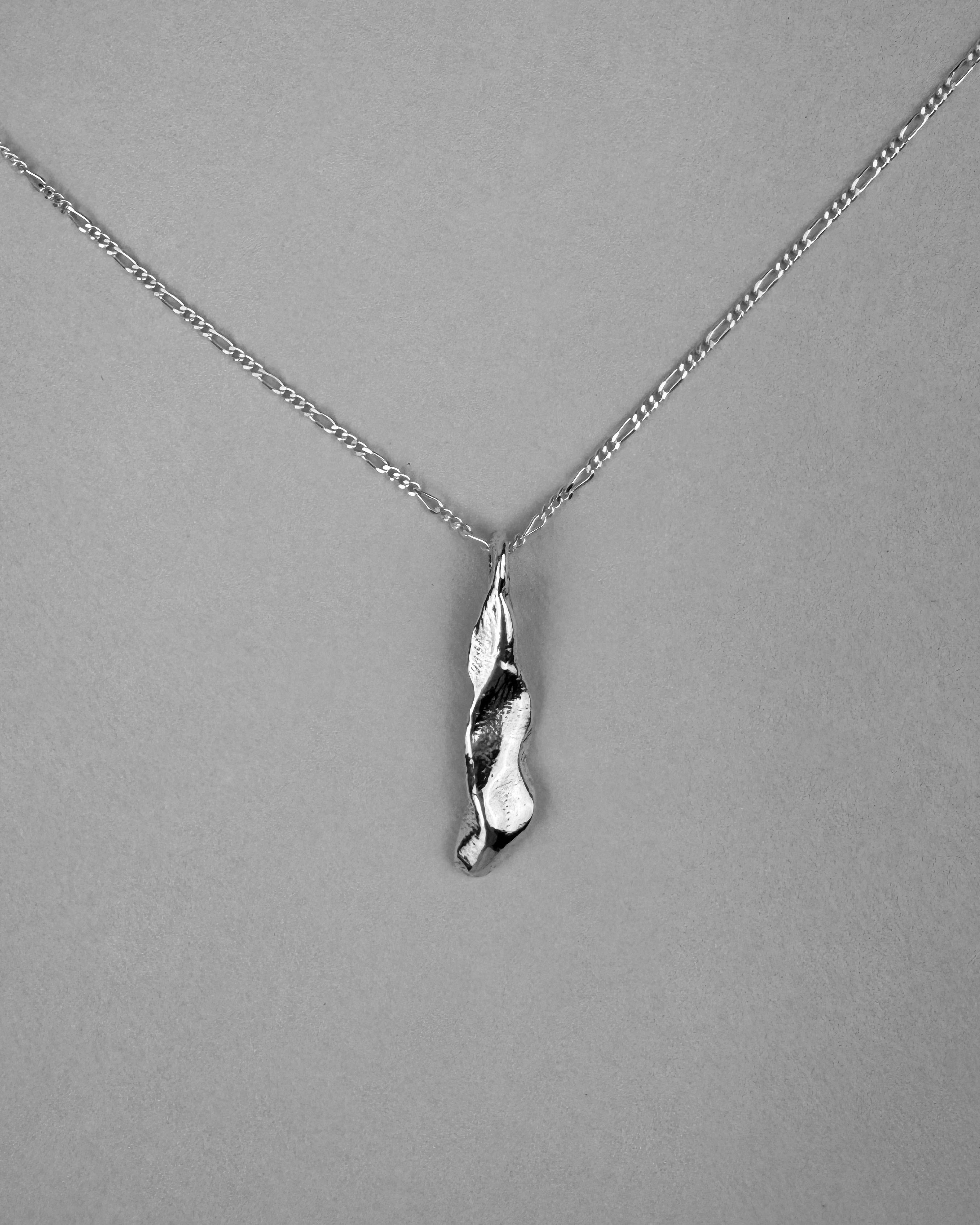 Silver necklace with a unique pendant on a gray background